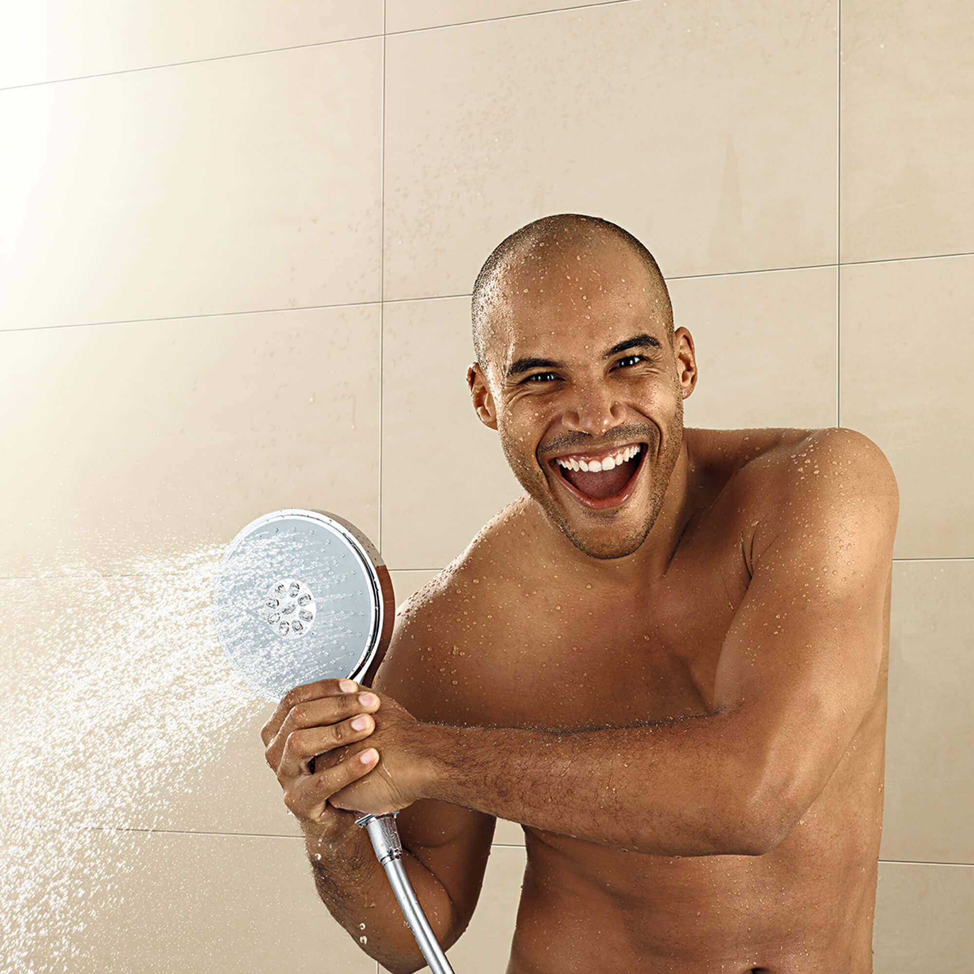 man spraying water using handheld showerhead